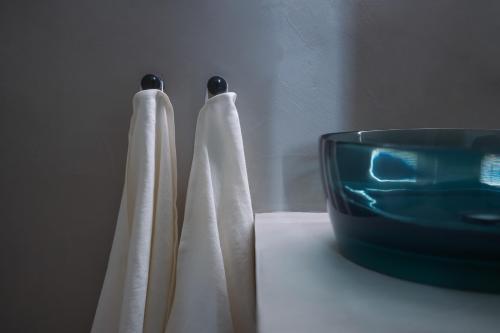 two towels on a counter next to a bowl at Palazzo Console in Lecce