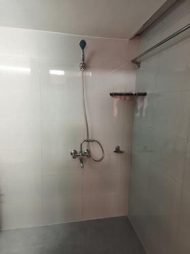 a bathroom with a shower with a shower head at Mimo's in Guwahati