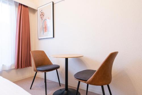 two chairs and a table in a room at Fujiterrace Yoga in Tokyo