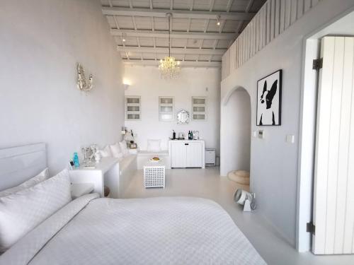 a white room with a bed and a desk at Ample Villa 小希臘民宿 in Ruifang