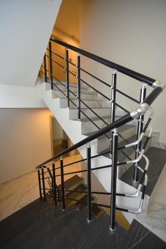 a staircase with black and white railings in a building at Hotel Avenue 30 in Yerevan