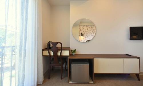 a room with a desk and a mirror on the wall at Hotel Avenue 30 in Yerevan