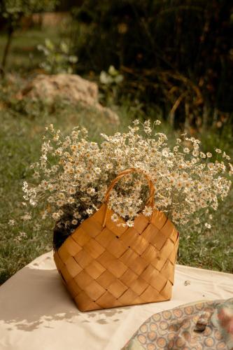 a basket with flowers in it sitting on a table at TREFOIL in Lori Berd