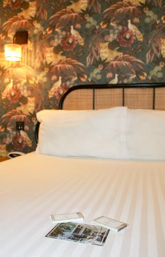 a book on a bed in a room at Hotel Edouard VII in Biarritz