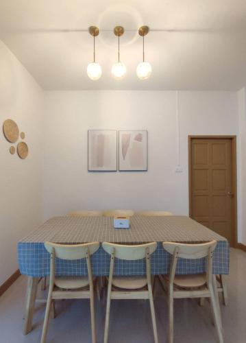 a dining room table with two chairs around it at DeliZia de Villa Satun พักได้ 9 ท่าน in Satun