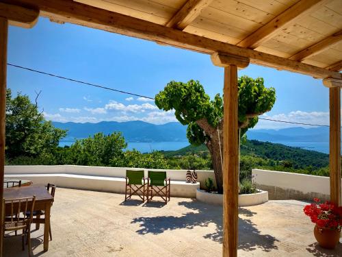 a view from the patio of a house with a table and chairs at Lichada Villa's in Likhás
