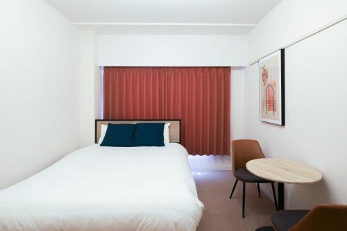 a hotel room with a bed and a table at Fujiterrace Yoga in Tokyo