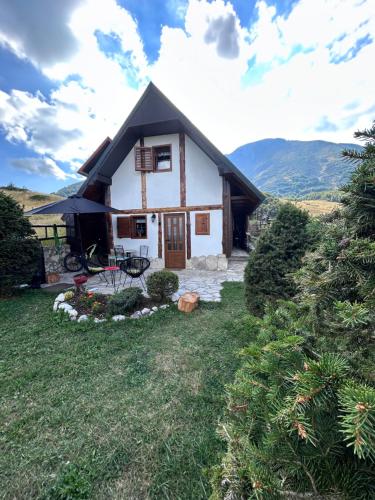 a white house with a black roof at NV Mountain House in Žabljak