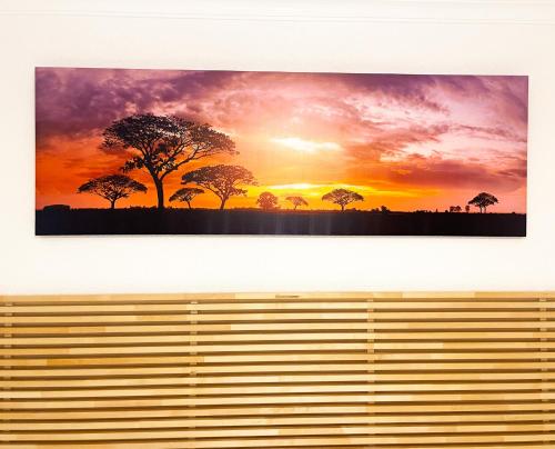 a picture of a sunset with trees in the background at Casa junto al Mar in El Ejido