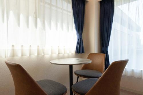 a room with two chairs and a table and a window at Fujiterrace Yoga in Tokyo