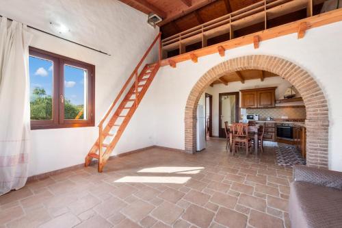 an archway in a kitchen with a staircase in a house at Villa Is Sorrisi in Gonnesa
