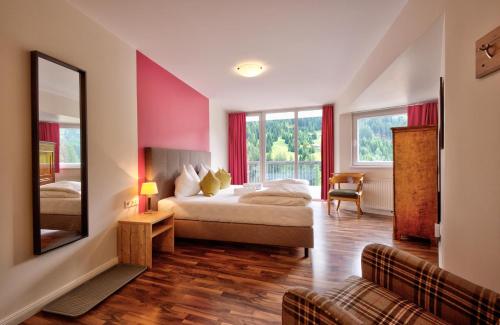 a hotel room with a bed and a mirror at Villa Chiara in Sankt Anton am Arlberg