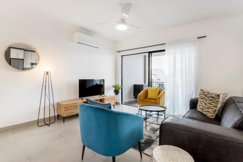 a living room with a couch and a table at Ballito Village Luxury Apartments in Ballito