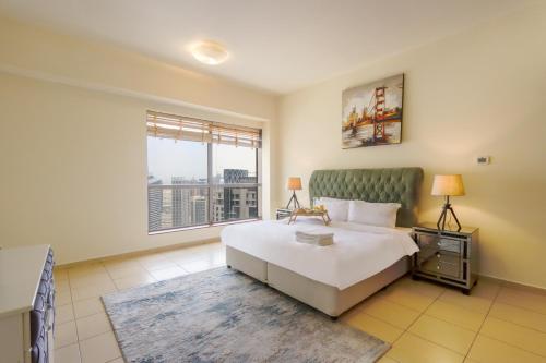 a bedroom with a large bed and a large window at JBR The Walk Rimal 5 Suites High Floor 3 Bedroom in Dubai