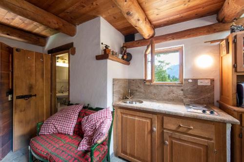 a kitchen with a couch and a sink in a room at Rustico Savinera - Happy Rentals in San Carlo