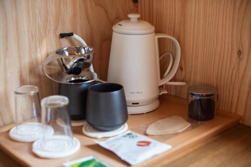 a kitchen counter with a coffee maker and a blender at HOTEL BOTH in Shari