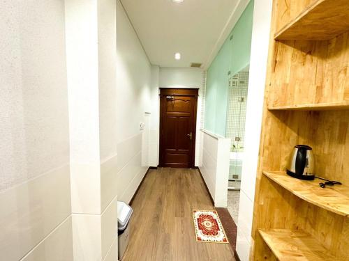 a hallway with a wooden door in a room at Nhan Tay 2 Hotel in Can Tho