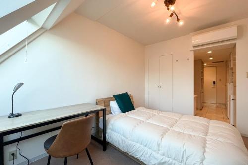 a bedroom with a bed and a desk and a chair at Fujiterrace Yoga in Tokyo