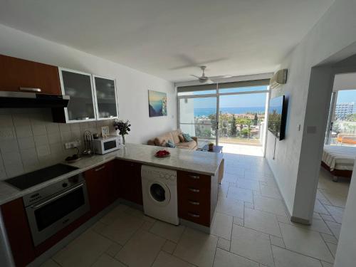 a kitchen with a washer and dryer in at Green Door Getaway in Limassol