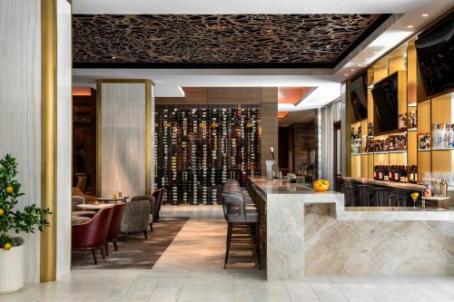 a bar in a restaurant with wine bottles at The Westin Anaheim Resort in Anaheim