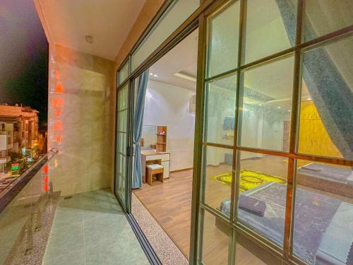 a room with large glass windows and a bedroom at NHÂN TÂY 2 HOTELs in Can Tho