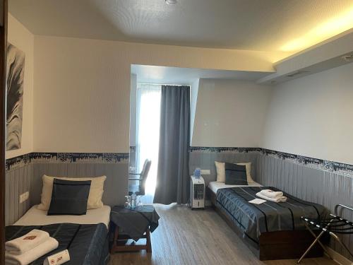 Postel nebo postele na pokoji v ubytování Hotel Corsten
