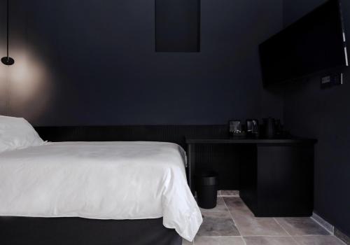 Ένα ή περισσότερα κρεβάτια σε δωμάτιο στο The Sendal Boutique Hotel