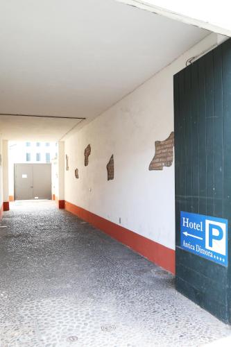 an empty room with a parking lot and a hotel sign on a wall at Hotel Mantegna Stazione, MantegnaHotels in Mantova
