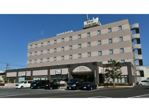 a large building with cars parked in front of it at Hotel Sunrise Choshi - Vacation STAY 73442v in Choshi