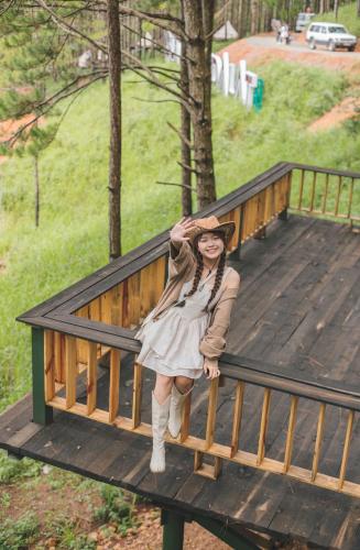 a woman is standing on a wooden ramp at Lavender Dalat Hotel and Resorts in Da Lat