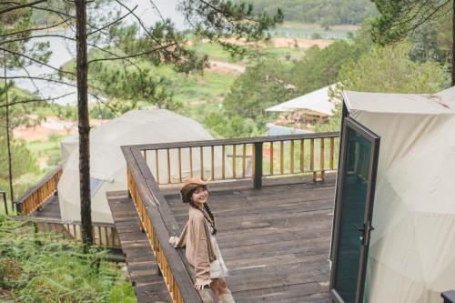a young girl walking down a wooden deck at Lavender Dalat Hotel and Resorts in Da Lat