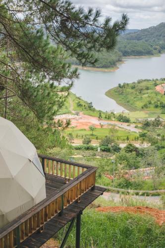 a wooden deck with a view of a lake at Lavender Dalat Hotel and Resorts in Da Lat