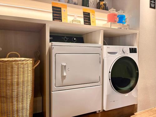 a white washer and dryer sitting on a shelf at Stanley Wahid Hasyim Jakarta in Jakarta