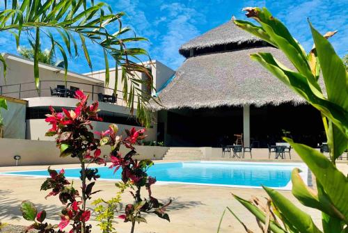 a view of a resort with a swimming pool at MAISON CARREE in Andilana