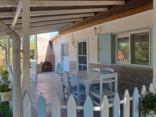 a patio with a white fence and a table and chairs at Mert Village house in Ortaca