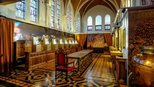 a church with a table and stained glass windows at La Merveilleuse by Infiniti hôtel in Dinant