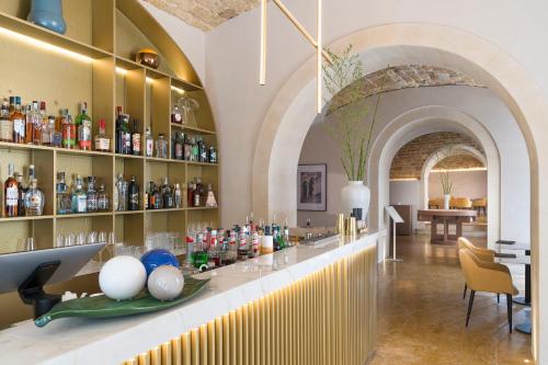 a bar in a building with a lot of bottles at Palazzo Artemide - VRetreats in Siracusa