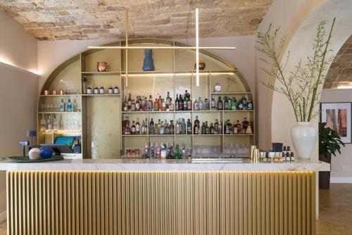 a bar with a yellow counter in a room at Palazzo Artemide - VRetreats in Siracusa
