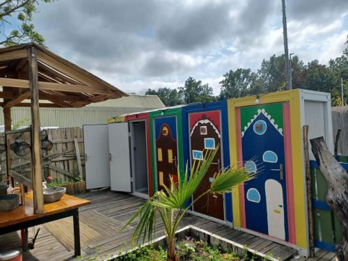 a row of colorful toilets on a deck at Stoke Travel's Amsterdam Camping in Amsterdam