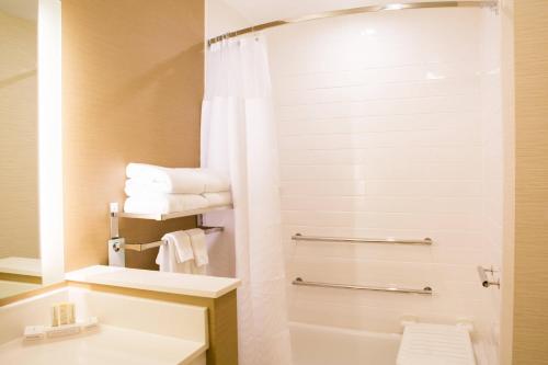 a bathroom with a toilet and a sink and a shower at Fairfield Inn & Suites by Marriott Sheridan in Sheridan