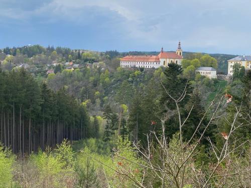 a town on top of a hill with trees at Hvězdný glamping in Manětín
