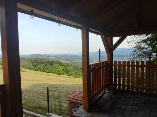 a screened in porch with a view of a field at OSADA WASYLÓWKA in Laskowa