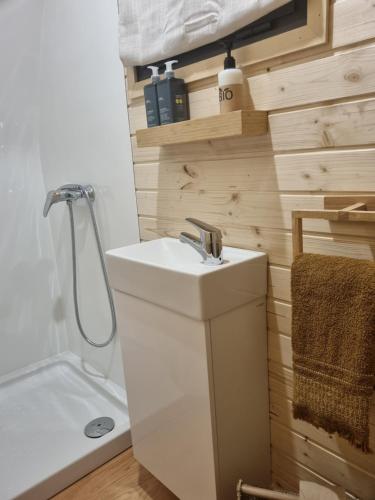a bathroom with a white sink and a shower at Eco Cabin - Villa das Alfarrobas in Algoz