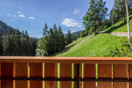 a wooden deck with a view of a hill at Bachwiesl Hof Apt Pichl in Proves