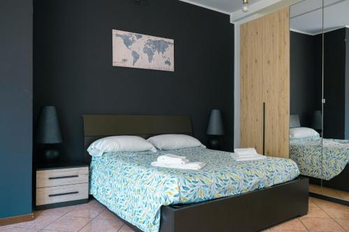 a bedroom with a bed and a mirror at Castelvecchio City Center Apartment in Verona