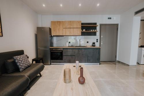 a living room with a couch and a table at Pearl Apartel in Volos