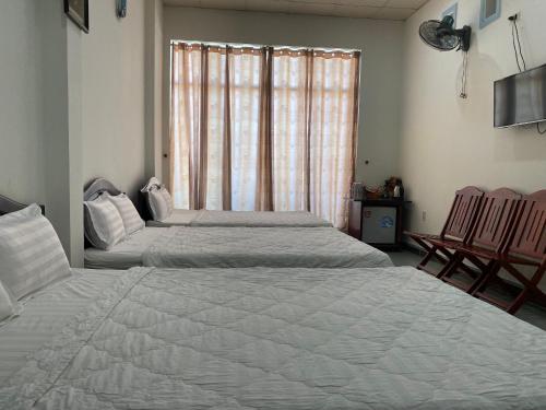 Una cama o camas en una habitación de Cát Tường Hotel