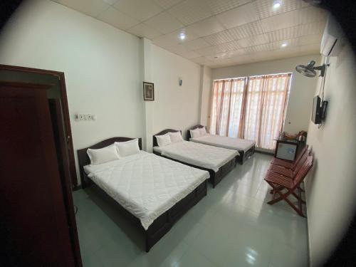 Una cama o camas en una habitación de Cát Tường Hotel