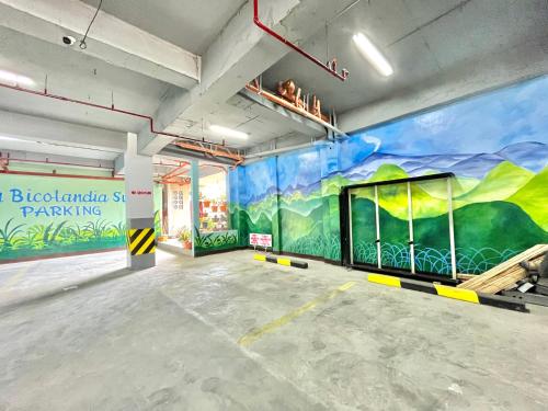 a room with a large mural on the wall at Casa Bicolandia Suites in Daraga