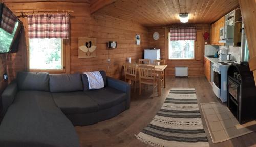 a living room with a couch and a table at Punatulkku in Kalajoki